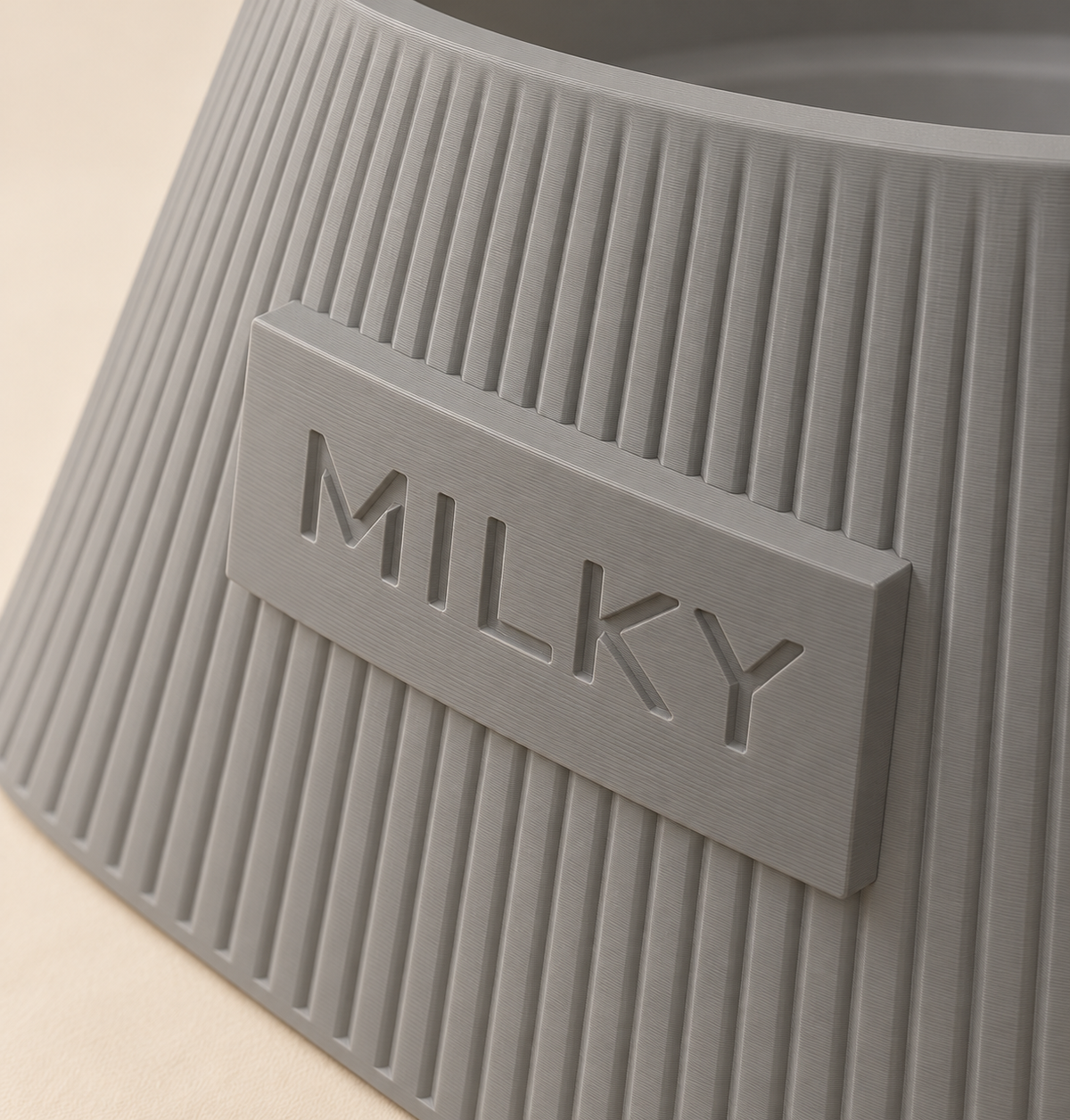 Frame in Ash Grey, close-up of the MILKY name and matte finish