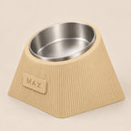Contour Tilt custom height dog bowl in Desert Tan, with a tilted stainless steel bowl, fine vertical grooves and MAX example nameplate.