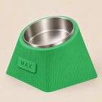 Contour Tilt custom height dog bowl in Grass Green, with a tilted stainless steel bowl, fine vertical grooves and MAX example nameplate.