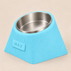 Contour Tilt custom height dog bowl in Ice Blue, with a tilted stainless steel bowl, fine vertical grooves and MAX example nameplate.