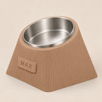 Contour Tilt custom height dog bowl in Latte Brown, with a tilted stainless steel bowl, fine vertical grooves and MAX example nameplate.