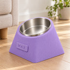 Lilac Purple Contour Tilt dog bowl in a softly lit home interior.