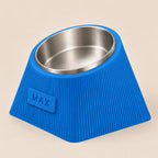 Contour Tilt custom height dog bowl in Marine Blue, with a tilted stainless steel bowl, fine vertical grooves and MAX example nameplate.