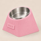 Contour Tilt custom height dog bowl in Sakura Pink, with a tilted stainless steel bowl, fine vertical grooves and MAX example nameplate.