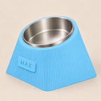 Contour Tilt custom height dog bowl in Sky Blue, with a tilted stainless steel bowl, fine vertical grooves and MAX example nameplate.